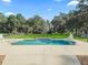 Sparkling pool with manicured landscaping, set against a peaceful backyard setting at 11831 Sw Highway 484, Dunnellon, FL 34432