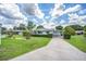 Inviting single-story home with a long driveway and meticulously maintained front yard landscaping at 10162 Sw 87Th Ter, Ocala, FL 34481