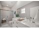 Modern bathroom featuring double vanity, quartz countertop, and glass-enclosed shower at 4544 Sw 156 Pl, Ocala, FL 34473