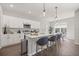 Modern kitchen featuring white cabinets, stainless steel appliances, quartz countertops, and stylish pendant lighting at 4544 Sw 156 Pl, Ocala, FL 34473