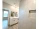 Bathroom with double sink vanity and a tiled walk-in shower featuring a niche at 4872 Sw 100Th St, Ocala, FL 34476