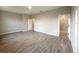 An empty bedroom featuring wood-look tile floors and a doorway leading to an en-suite bathroom with a tiled shower at 4872 Sw 100Th St, Ocala, FL 34476