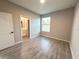 This bedroom features a window, a closet that goes into the bathroom, and tile floors at 4872 Sw 100Th St, Ocala, FL 34476