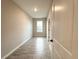 An empty bedroom features wood-look tile floors and a single window at 4872 Sw 100Th St, Ocala, FL 34476