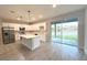 Modern kitchen with white cabinets, stainless steel appliances, and a center island at 4872 Sw 100Th St, Ocala, FL 34476