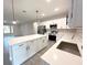 Bright kitchen with white cabinets, a large island, and modern pendant lighting at 4872 Sw 100Th St, Ocala, FL 34476