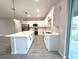 Modern kitchen featuring white cabinetry, quartz countertops, and stainless steel appliances at 4872 Sw 100Th St, Ocala, FL 34476