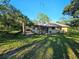 Large screened lanai and lush backyard with tropical landscaping at 9180 Sw 202Nd Avenue Road, Dunnellon, FL 34431