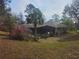 Spacious backyard with pool and mature landscaping, including palm tree at 9180 Sw 202Nd Avenue Road, Dunnellon, FL 34431