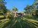 Spacious backyard featuring mature trees and screened lanai at 9180 Sw 202Nd Avenue Road, Dunnellon, FL 34431