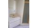 Bathroom featuring a single sink vanity and a glass-enclosed shower stall at 9180 Sw 202Nd Avenue Road, Dunnellon, FL 34431