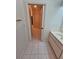 Bathroom featuring a vanity and tile flooring leading to a hallway at 9180 Sw 202Nd Avenue Road, Dunnellon, FL 34431