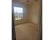 Bedroom with neutral carpet, ceiling fan and large window, and a double door closet at 9180 Sw 202Nd Avenue Road, Dunnellon, FL 34431