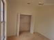 Bedroom closet with ceiling fan, window, neutral carpet, and a double door closet at 9180 Sw 202Nd Avenue Road, Dunnellon, FL 34431