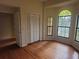 Bright bedroom with wood floors, closet, and stained glass window at 9180 Sw 202Nd Avenue Road, Dunnellon, FL 34431