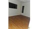 Bedroom featuring hardwood floors, a ceiling fan, and two windows at 9180 Sw 202Nd Avenue Road, Dunnellon, FL 34431