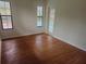 Bedroom featuring wood floors and French doors leading to the pool area at 9180 Sw 202Nd Avenue Road, Dunnellon, FL 34431