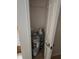 Small closet with a shelf featuring paint buckets inside at 9180 Sw 202Nd Avenue Road, Dunnellon, FL 34431