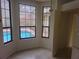 Dining area with tile floor, natural light, and view of the pool at 9180 Sw 202Nd Avenue Road, Dunnellon, FL 34431