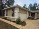 Charming home featuring a brick driveway, an attached two-car garage, and stucco siding at 9180 Sw 202Nd Avenue Road, Dunnellon, FL 34431