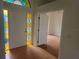 Inviting foyer showcasing the front door with stained glass and the entrance to the living room at 9180 Sw 202Nd Avenue Road, Dunnellon, FL 34431