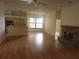 Open living room with wood floors, brick fireplace, and natural light from a large window at 9180 Sw 202Nd Avenue Road, Dunnellon, FL 34431