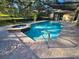 Sparkling screened in pool and spa offer a refreshing escape at 9180 Sw 202Nd Avenue Road, Dunnellon, FL 34431