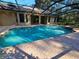 Private screened pool area with brick pavers and lush landscaping at 9180 Sw 202Nd Avenue Road, Dunnellon, FL 34431