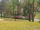 Residential lot with landscaped flowerbeds and mature trees at 9180 Sw 202Nd Avenue Road, Dunnellon, FL 34431