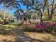 Charming home with a welcoming porch, complemented by beautiful landscaping and mature trees surrounding the property at 7545 Ne 58Th Ave, Anthony, FL 32617