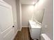 Bathroom featuring a double sink vanity with modern fixtures and wood-look tile floor at 4062 Sw 114Th St, Ocala, FL 34476