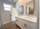 Modern bathroom with double vanity, stylish mirrors, and ceramic tile flooring at 4062 Sw 114Th St, Ocala, FL 34476