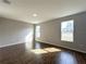 Bright bedroom with wood-look tile flooring and two large windows at 4062 Sw 114Th St, Ocala, FL 34476