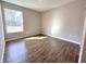 Neutral bedroom features wood-look tile flooring and a window for plenty of natural light at 4062 Sw 114Th St, Ocala, FL 34476