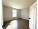 Bright, minimalist bedroom with a large window and wood-look tile flooring at 4062 Sw 114Th St, Ocala, FL 34476