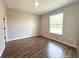 A simple bedroom with tile flooring and natural light from a single window at 4062 Sw 114Th St, Ocala, FL 34476