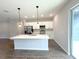 Modern kitchen features an island with pendant lights, stainless steel appliances, and shaker style cabinetry at 4062 Sw 114Th St, Ocala, FL 34476