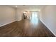 The light-filled living room boasts wood-look tile floors, and an open floor plan connecting the kitchen and dining area at 4062 Sw 114Th St, Ocala, FL 34476