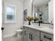 Contemporary bathroom with gray vanity and marble-look tile at 925 Se 13Th St, Ocala, FL 34471