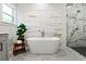 Elegant bathroom with soaking tub, marble shower, and gray vanity at 925 Se 13Th St, Ocala, FL 34471