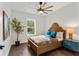 Bright bedroom with wood flooring, a ceiling fan, and a neutral color palette at 925 Se 13Th St, Ocala, FL 34471