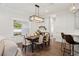 Bright dining room features a rustic table, chandelier, and hardwood floors at 925 Se 13Th St, Ocala, FL 34471