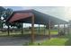 Open-sided metal shelter for storing equipment and vehicles at 15700 Se 36Th Ave, Summerfield, FL 34491