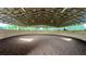 Indoor riding arena with a dirt floor and high wooden ceiling at 15700 Se 36Th Ave, Summerfield, FL 34491