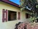 Exterior view of a light yellow stable with red window shutters at 15700 Se 36Th Ave, Summerfield, FL 34491