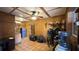 Tack room with wooden walls, ceiling fan, and storage for riding equipment at 15700 Se 36Th Ave, Summerfield, FL 34491