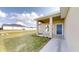 Front porch of a single story home with blue door and walkway at 5348 Se 91St Pl, Ocala, FL 34480