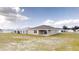 Rear view of a single story home with a covered patio at 5348 Se 91St Pl, Ocala, FL 34480