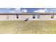 Rear view of house showcasing a large backyard and AC unit at 5348 Se 91St Pl, Ocala, FL 34480