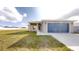 Front view of house with a two-car garage and landscaped lawn at 5348 Se 91St Pl, Ocala, FL 34480